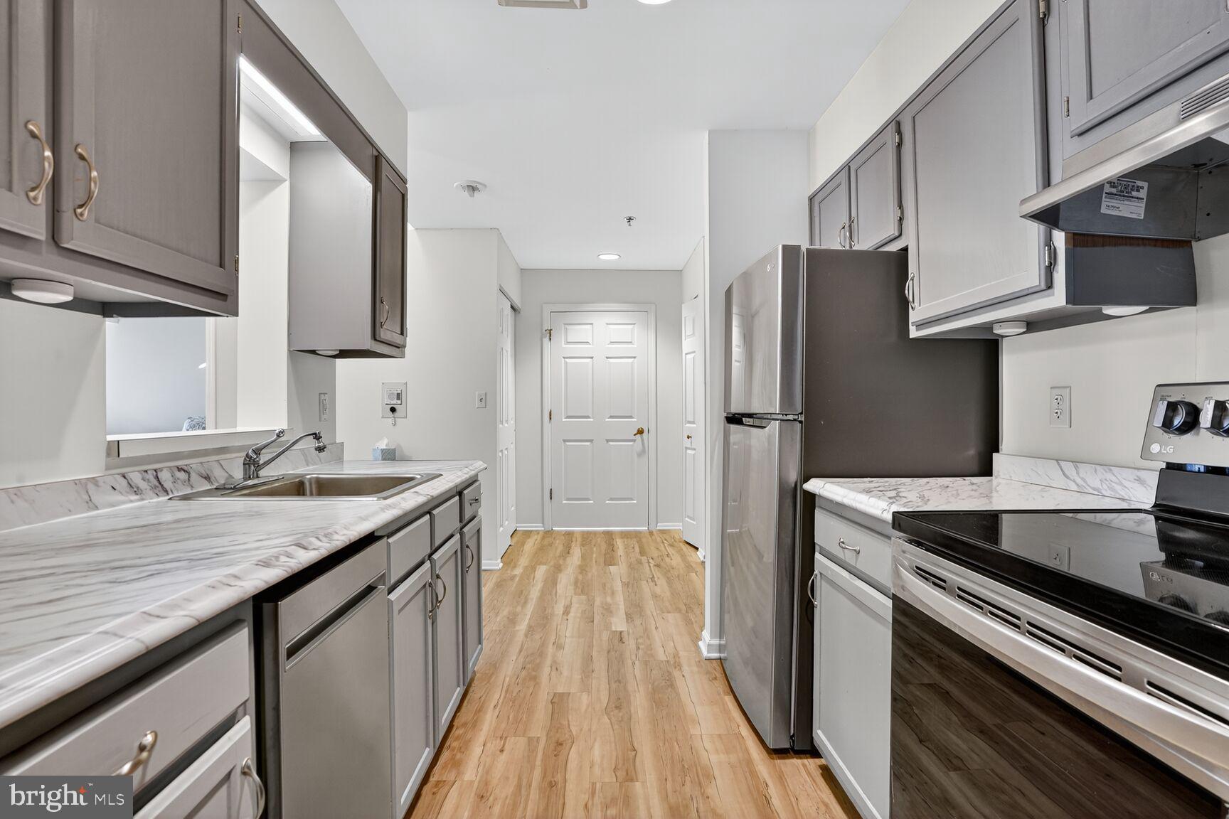 900 North Taylor Street, Unit 2110 Arlington, VA 22203 - Photo 6 of 42 a kitchen with stainless steel appliances granite countertop a sink stove and refrigerator