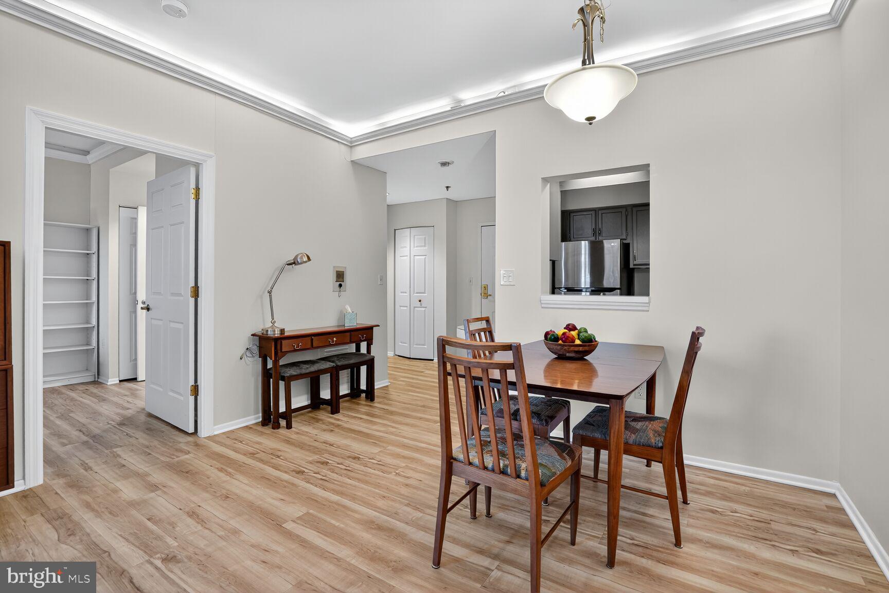 900 North Taylor Street, Unit 2110 Arlington, VA 22203 - Photo 9 of 42 a view of a dining room with furniture and wooden floor