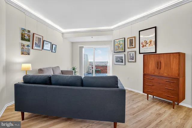 a living room with furniture and a cabinet