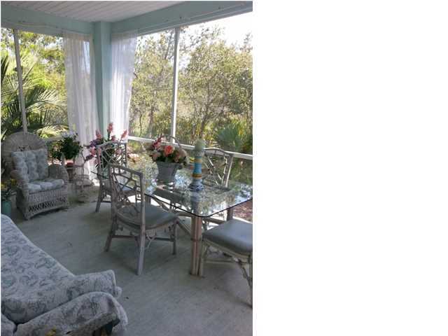 425 Golf Club Drive Santa Rosa Beach, FL 32459 - Photo 11 of 23 a dining room with furniture and a large window