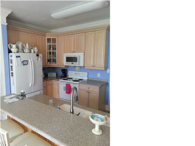425 Golf Club Drive Santa Rosa Beach, FL 32459 - Photo 12 of 23 a kitchen with a refrigerator and a stove top oven