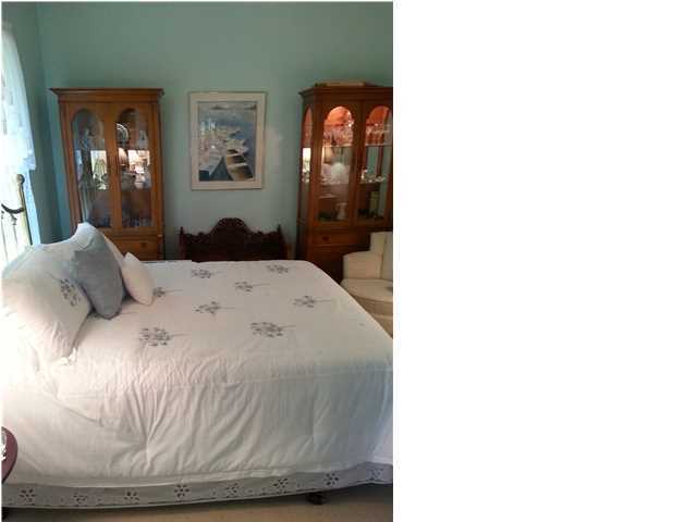 425 Golf Club Drive Santa Rosa Beach, FL 32459 - Photo 13 of 23 a view of a bedroom with a bed and glass door