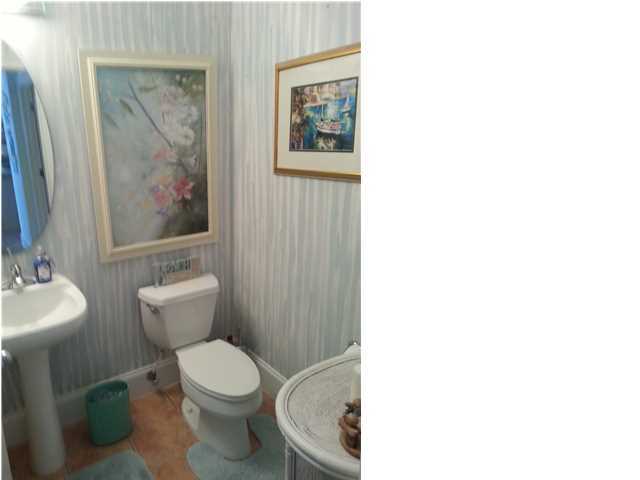425 Golf Club Drive Santa Rosa Beach, FL 32459 - Photo 16 of 23 a white toilet sitting next to a bathroom sink