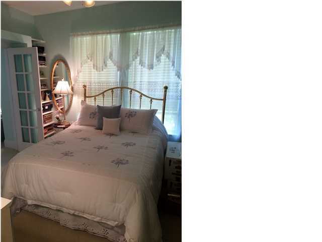 425 Golf Club Drive Santa Rosa Beach, FL 32459 - Photo 19 of 23 a bedroom with a bed next to a large window