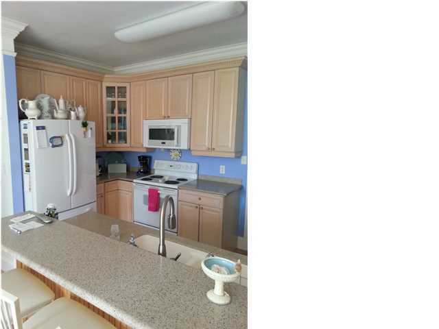 425 Golf Club Drive Santa Rosa Beach, FL 32459 - Photo 2 of 23 a kitchen with a refrigerator and a stove top oven