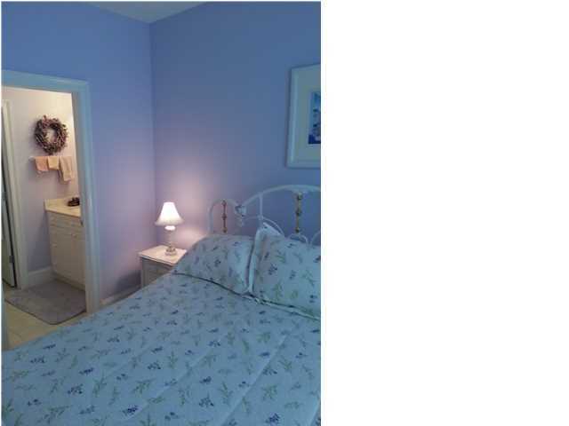 425 Golf Club Drive Santa Rosa Beach, FL 32459 - Photo 10 of 23 a bedroom with a bed and a lamp