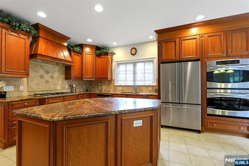 22 Meadowlake Drive Mahwah, NJ 07430 - Photo 13 of 39 a kitchen with stainless steel appliances granite countertop a refrigerator a stove and a sink