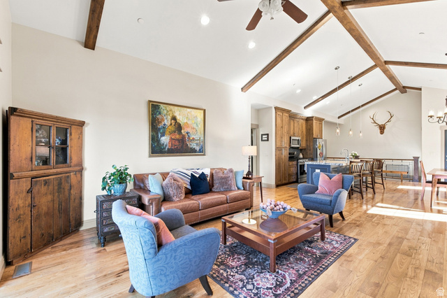 5207 North Oldgate Road Heber City, UT 84032 - Photo 10 of 58 Vaulted ceiling with exposed wood beams, wood-finish flooring throughout, recessed lighting, built-in wooden cabinetry, and stainless steel appliances
