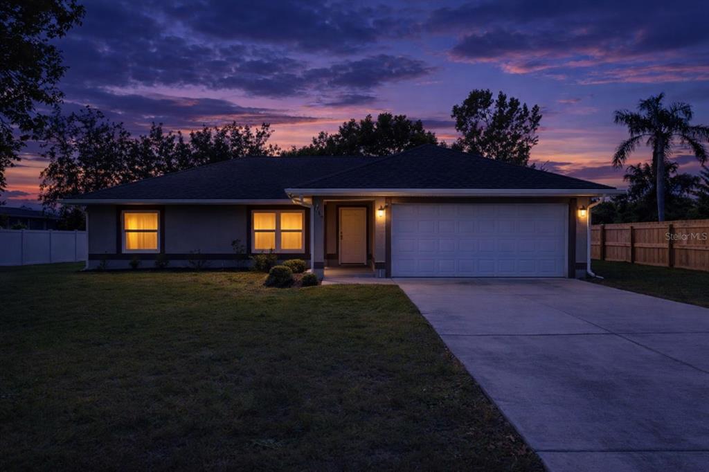 1049 Pinder Street Deltona, FL 32725 - Photo 1 of 20 a front view of a house with a garden