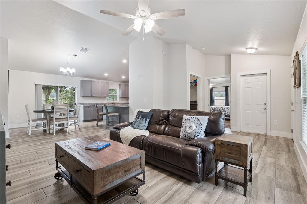 1049 Pinder Street Deltona, FL 32725 - Photo 4 of 20 a living room with furniture and a wooden floor