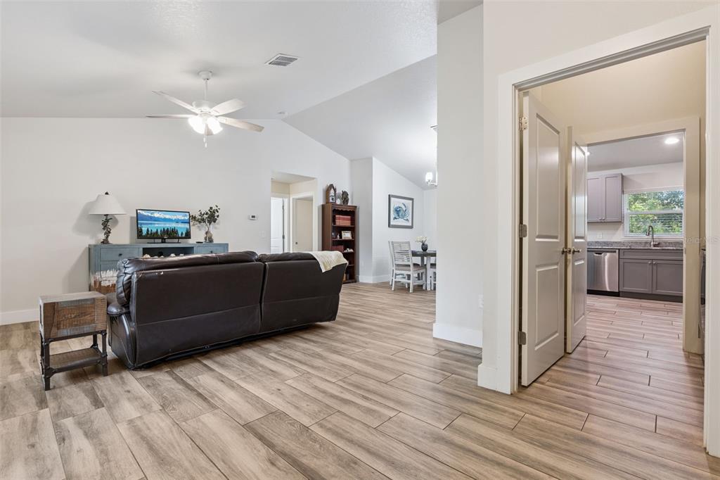 1049 Pinder Street Deltona, FL 32725 - Photo 6 of 20 a living room with furniture and a wooden floor
