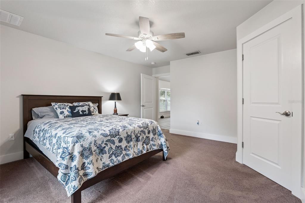1049 Pinder Street Deltona, FL 32725 - Photo 10 of 20 a bedroom with a bed and a ceiling fan