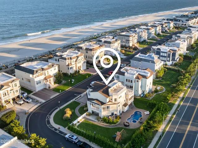 a aerial view of a house with outdoor space pool seating area and yard