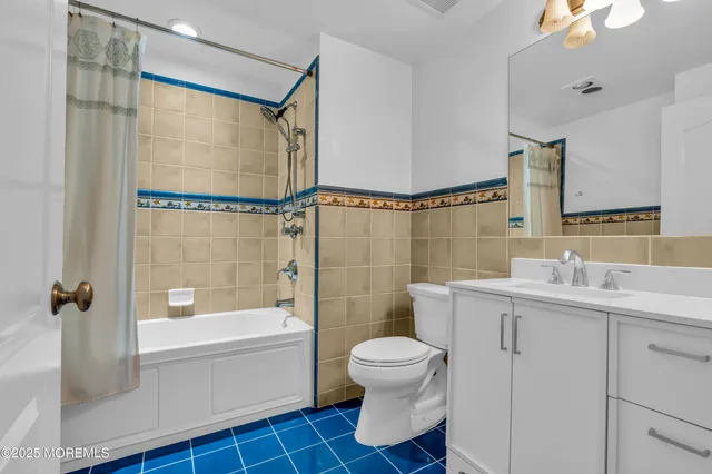 a bed room with two beds and a chandelier