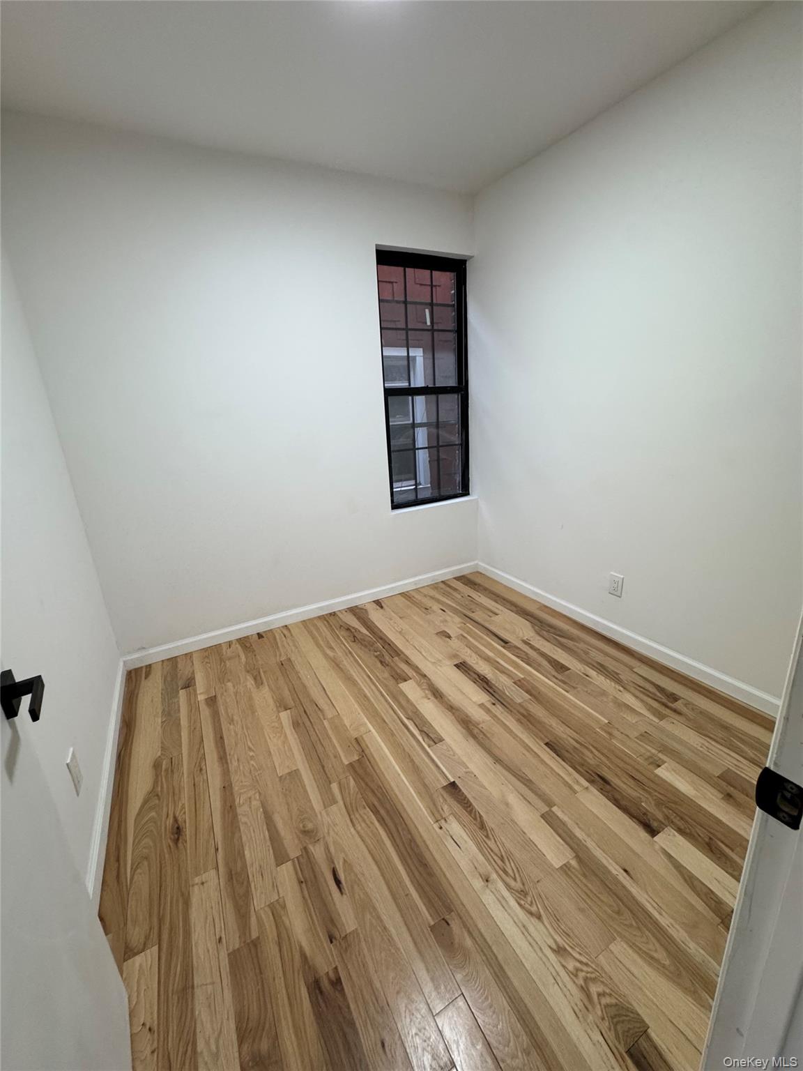 1827 Amethyst Street, Unit 2 Bronx, NY 10462 - Photo 7 of 9 a view of a room with wooden floor