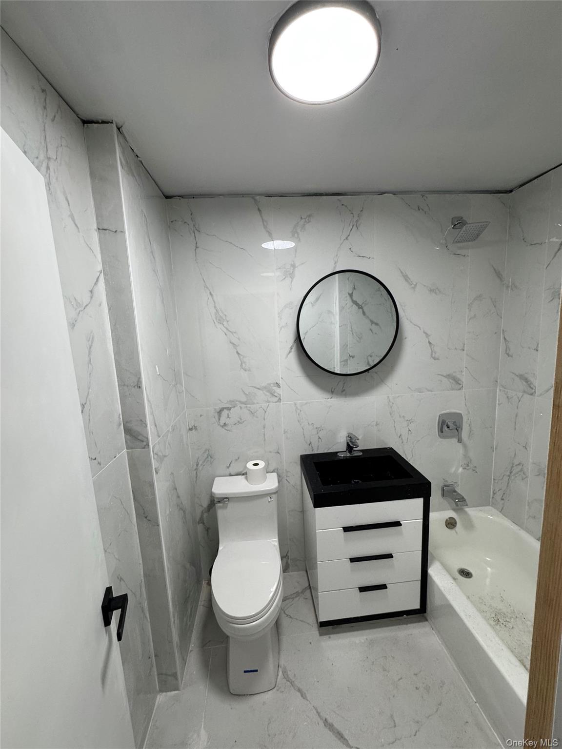 1827 Amethyst Street, Unit 2 Bronx, NY 10462 - Photo 9 of 9 a bathroom with a sink a toilet and a bathtub