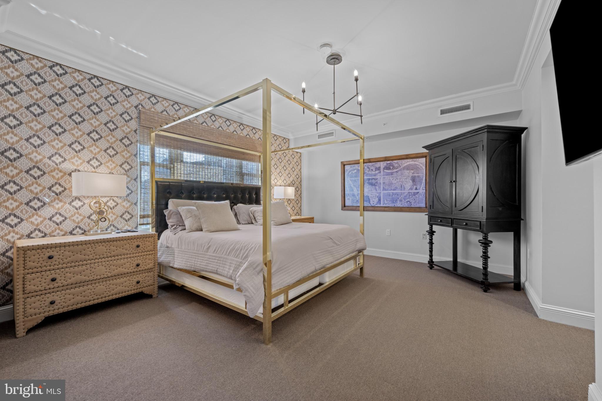 801 Key Highway, Unit 458 Baltimore, MD 21230 - Photo 19 of 48 a bedroom with a bed chandelier and a window