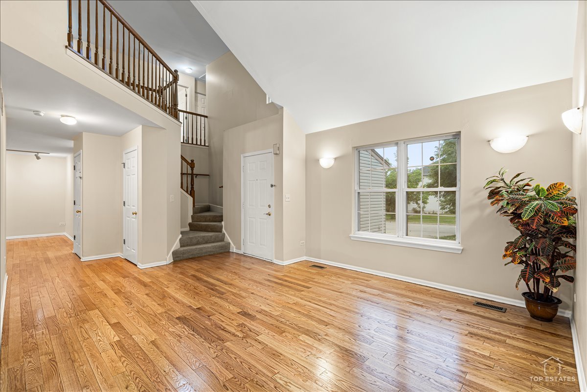 7 Eagle Court Streamwood, IL 60107 - Photo 4 of 31 a view of an empty room with wooden floor and a window