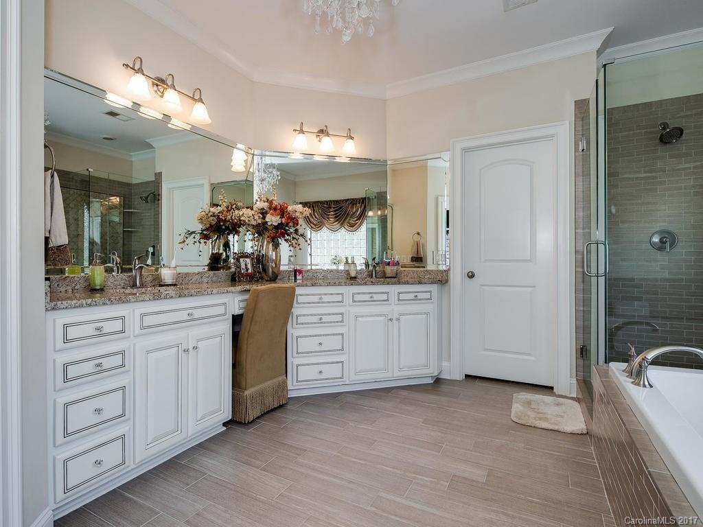 3223 Millstone Creek Road, Unit 2 Lancaster, SC 29720 - Photo 20 of 24 a bathroom with a double vanity sink a mirror a bathtub and shower
