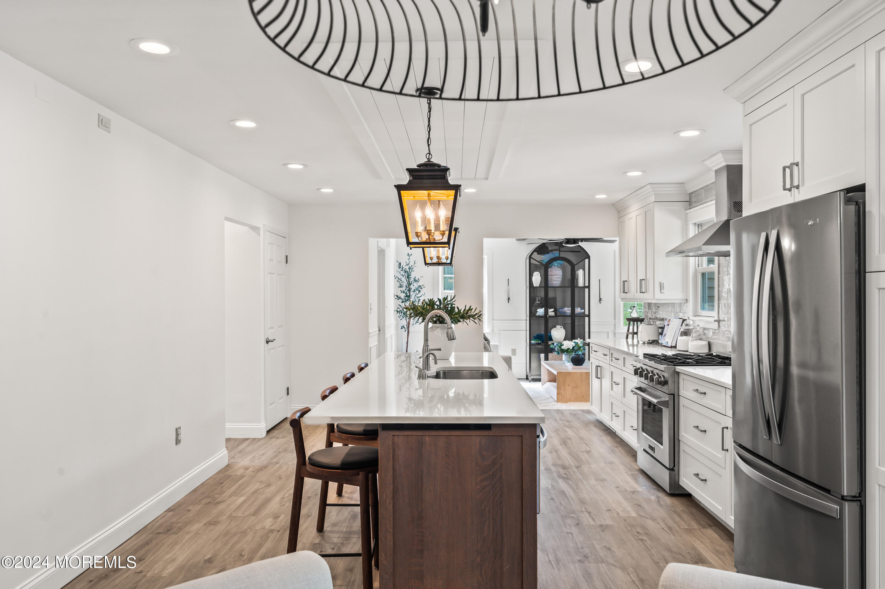 17 Mary Beth Lane Jackson, NJ 08527 - Photo 6 of 61 a kitchen with stainless steel appliances a refrigerator a sink dishwasher a stove and a dining table with wooden floor