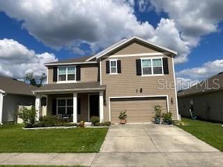 5911 Southwest 84th Street Gainesville, FL 32608 - Photo 1 of 30 a front view of a house with a yard