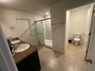 5911 Southwest 84th Street Gainesville, FL 32608 - Photo 11 of 30 a bathroom with a granite countertop sink and a mirror