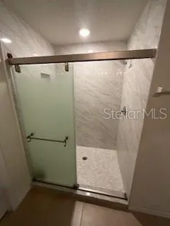a bathroom with a shower and a sink