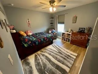 a bed sitting in a bedroom and chair