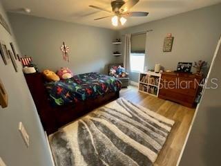 5911 Southwest 84th Street Gainesville, FL 32608 - Photo 19 of 30 a bed sitting in a bedroom and chair