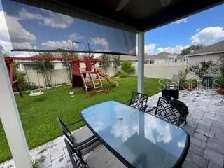 a view of a porch with furniture and garden