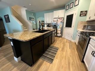 5911 Southwest 84th Street Gainesville, FL 32608 - Photo 28 of 30 a kitchen with stainless steel appliances granite countertop a stove a sink dishwasher and a refrigerator