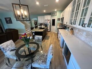 5911 Southwest 84th Street Gainesville, FL 32608 - Photo 29 of 30 a living room with furniture and a chandelier