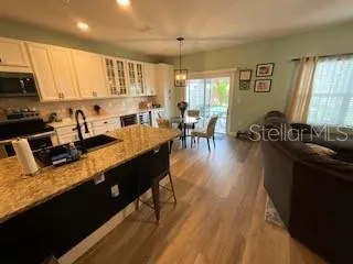 a kitchen with stainless steel appliances granite countertop sink stove top oven and cabinets