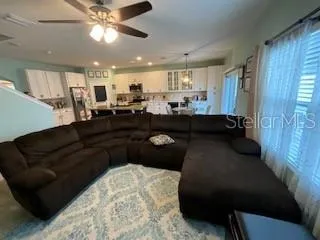 a living room with furniture and a chandelier