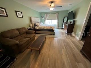 5911 Southwest 84th Street Gainesville, FL 32608 - Photo 10 of 30 a living room with furniture and a wooden floor