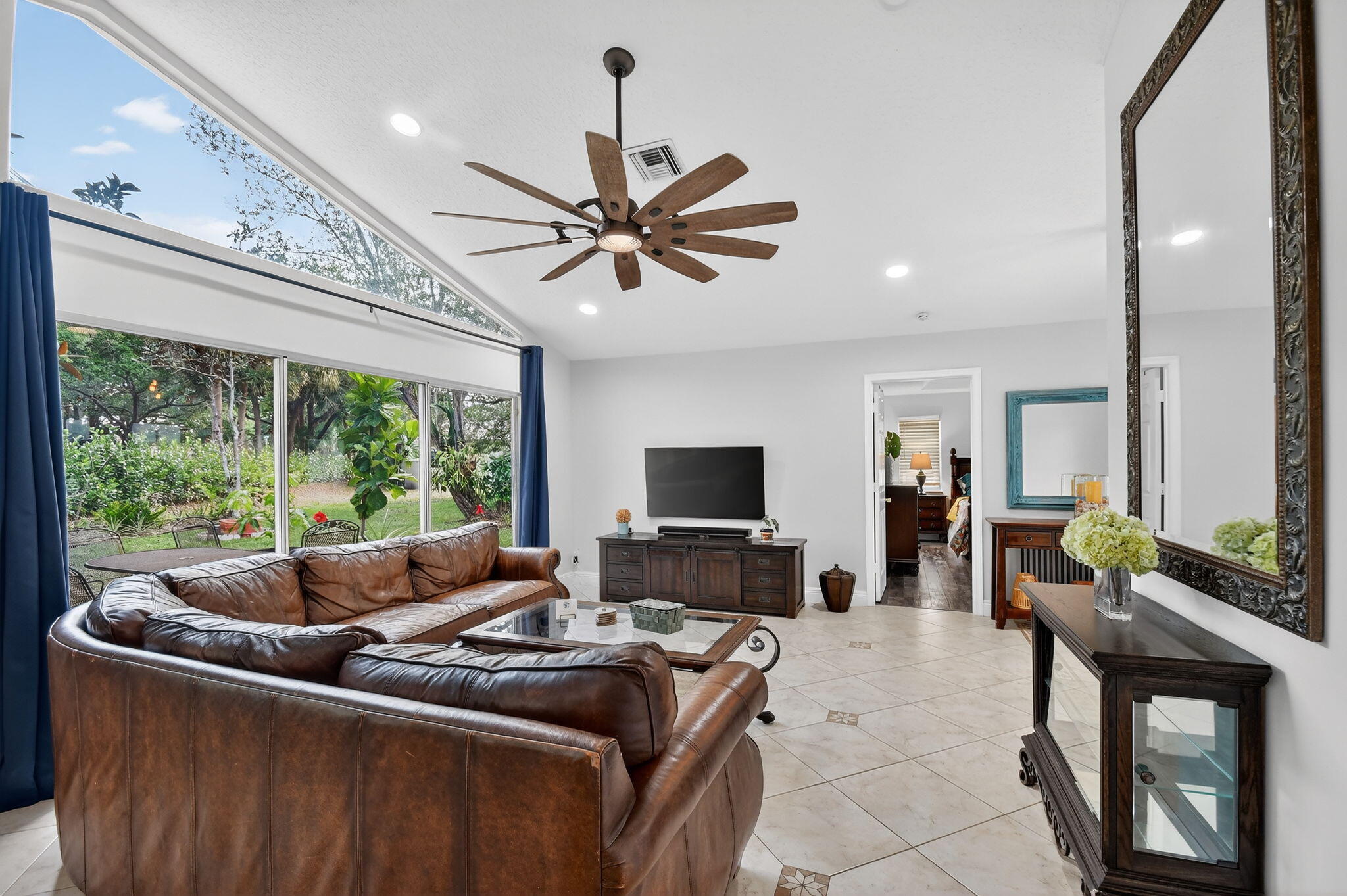 2769 Pointe Circle Greenacres, FL 33413 - Photo 11 of 48 a living room with furniture a flat screen tv and a large window