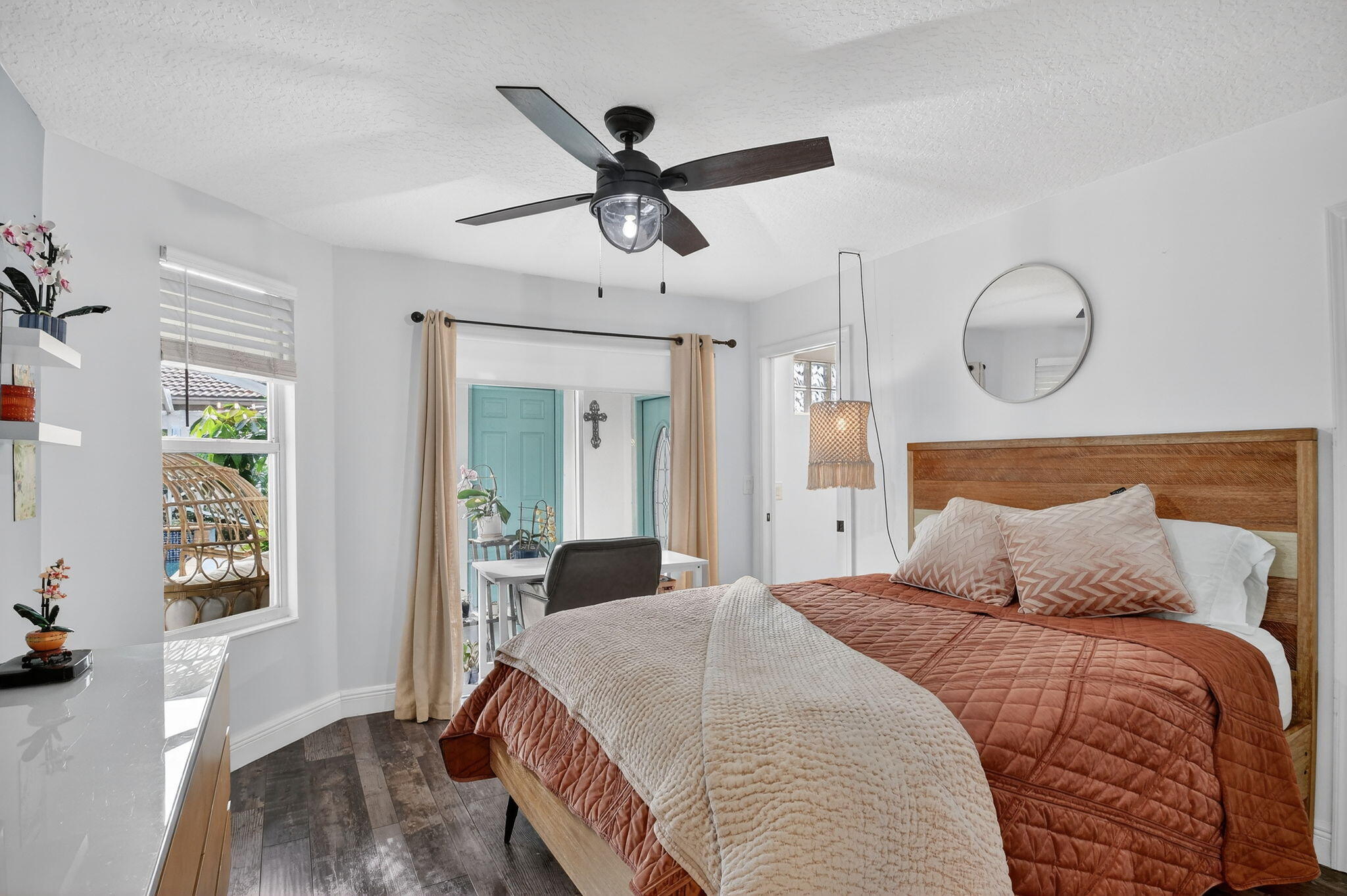 2769 Pointe Circle Greenacres, FL 33413 - Photo 26 of 48 a bedroom with a large bed and a chandelier