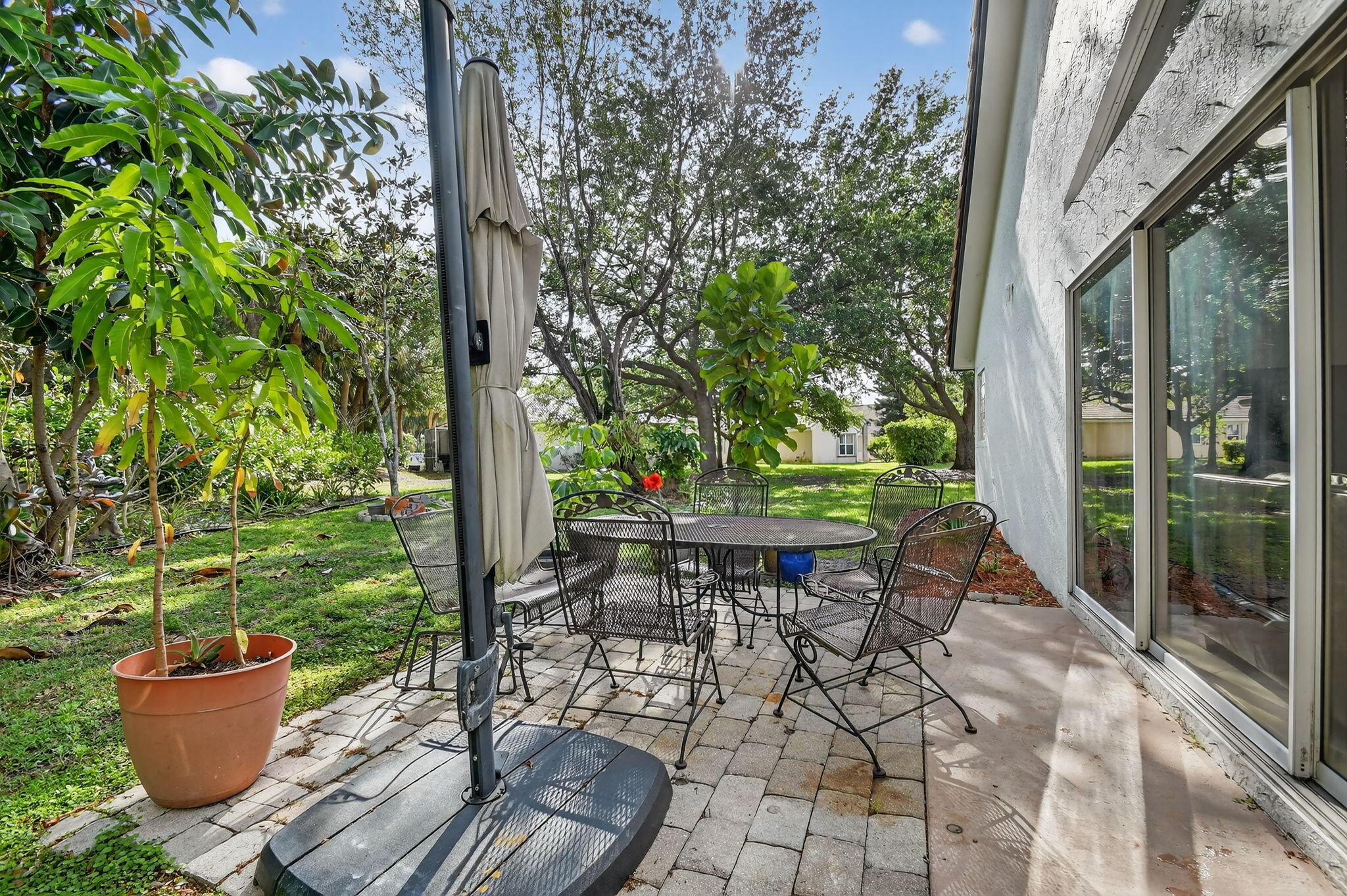 2769 Pointe Circle Greenacres, FL 33413 - Photo 33 of 48 a view of a chairs and table in backyard of the house