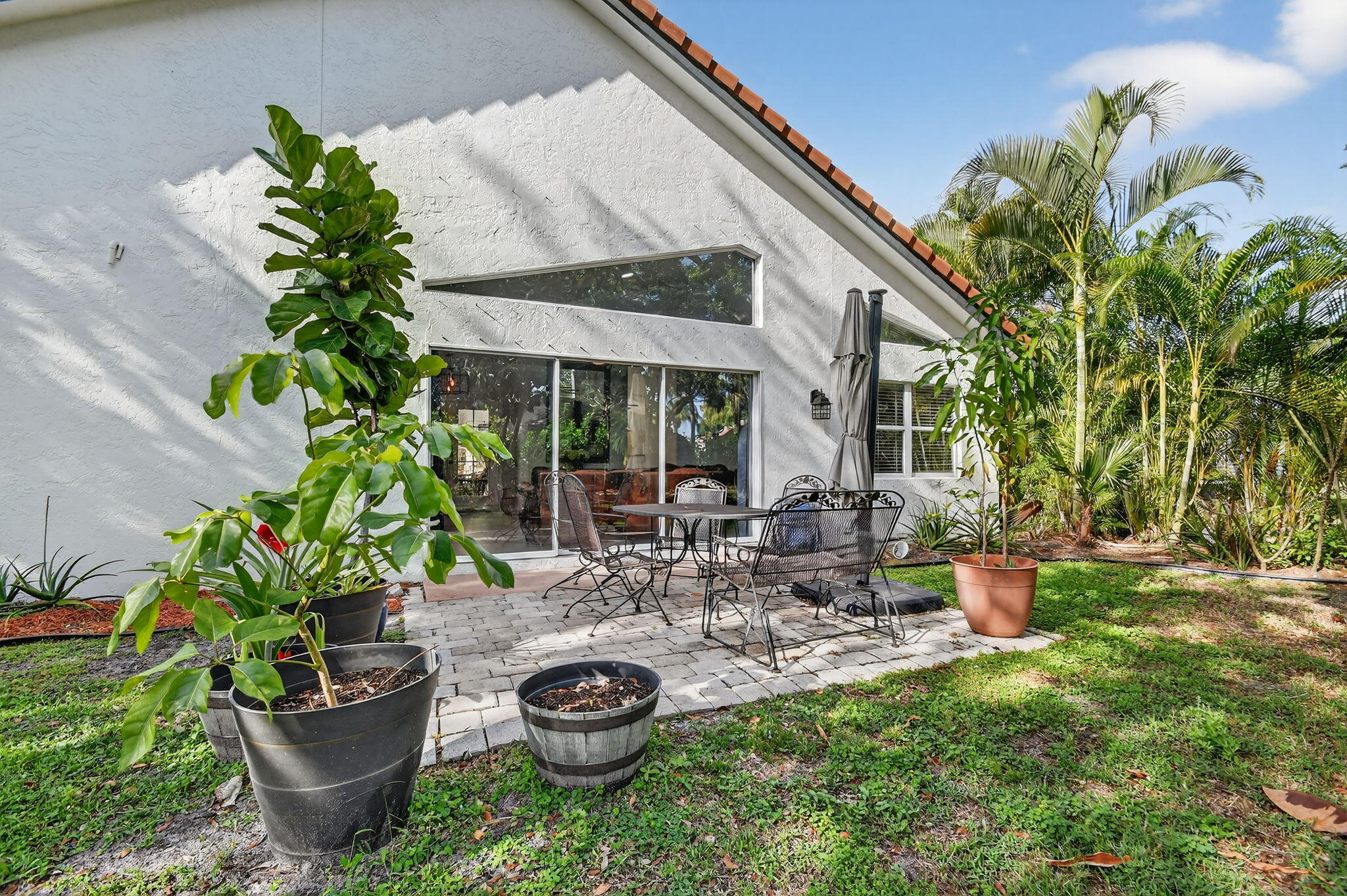 2769 Pointe Circle Greenacres, FL 33413 - Photo 34 of 48 a view of a backyard with plants and a patio