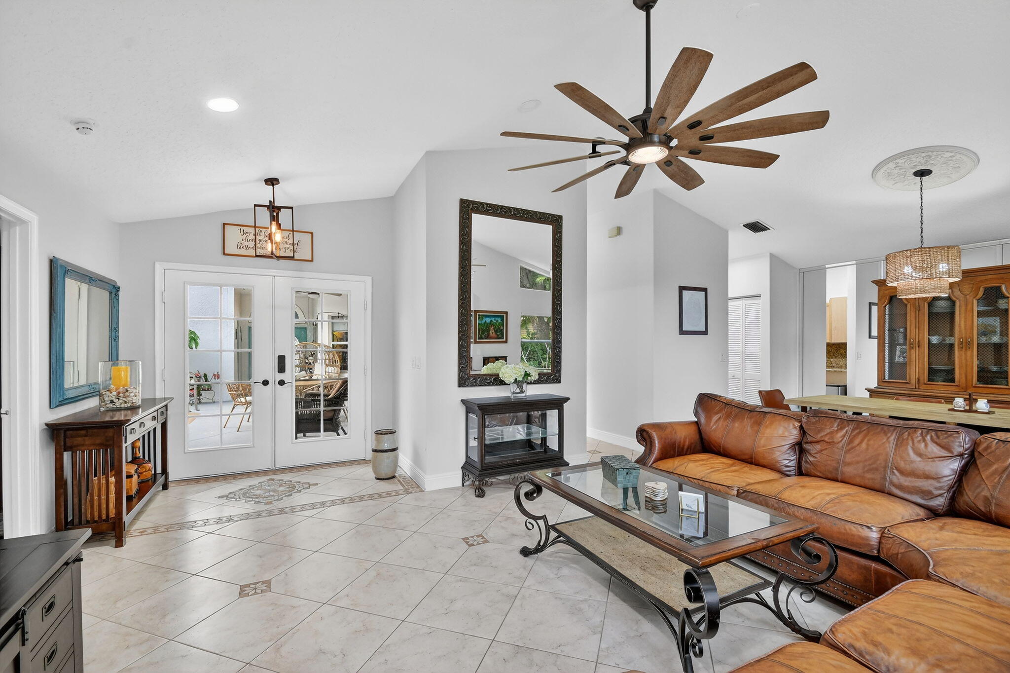 2769 Pointe Circle Greenacres, FL 33413 - Photo 10 of 48 a living room with furniture a dining table and a fireplace
