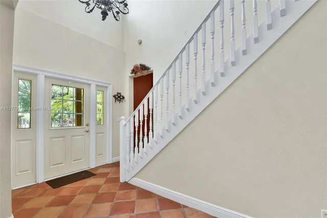 a view of staircase with wooden floor and white walls