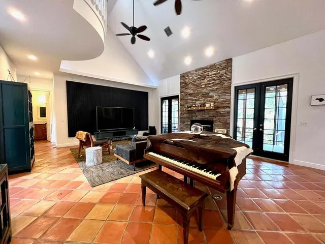 a living room with furniture a flat screen tv and a fireplace