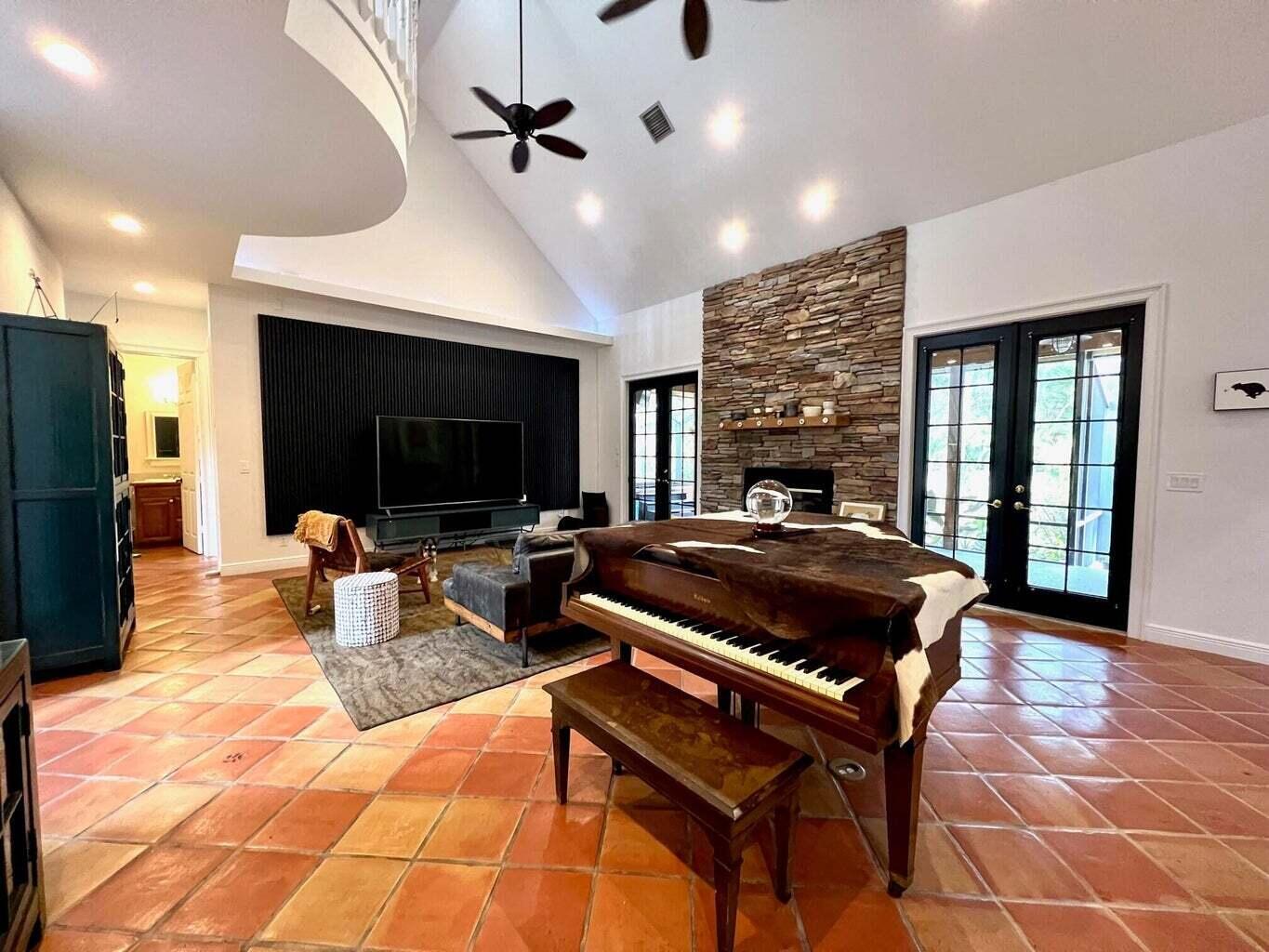 14425 North 64th Court North Loxahatchee, FL 33470 - Photo 13 of 36 a living room with furniture a flat screen tv and a fireplace