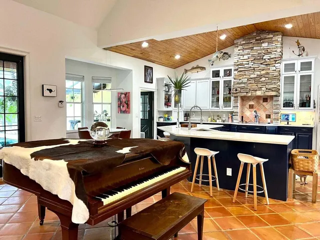 a kitchen with a table chairs and wooden floor