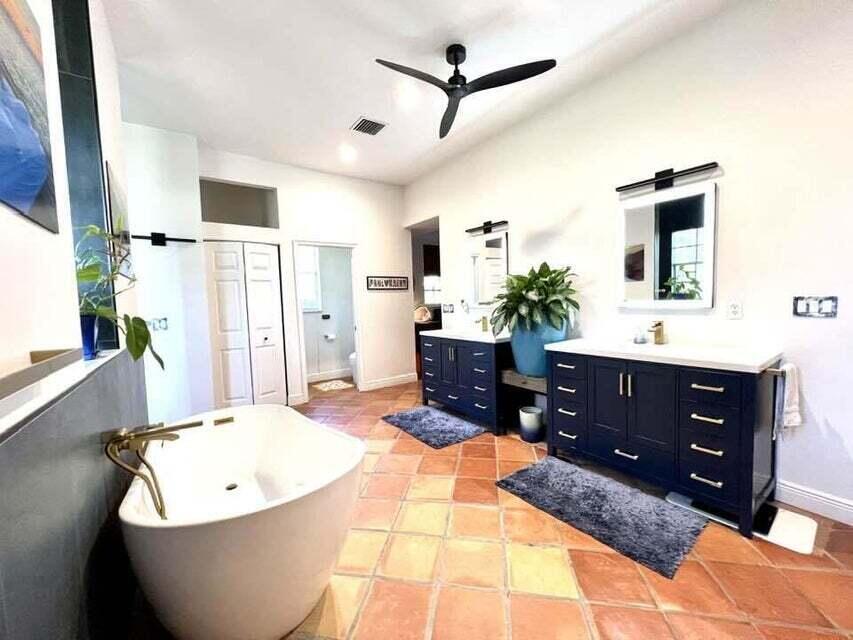 14425 North 64th Court North Loxahatchee, FL 33470 - Photo 21 of 36 a living room with a couch and a dresser with wooden floor