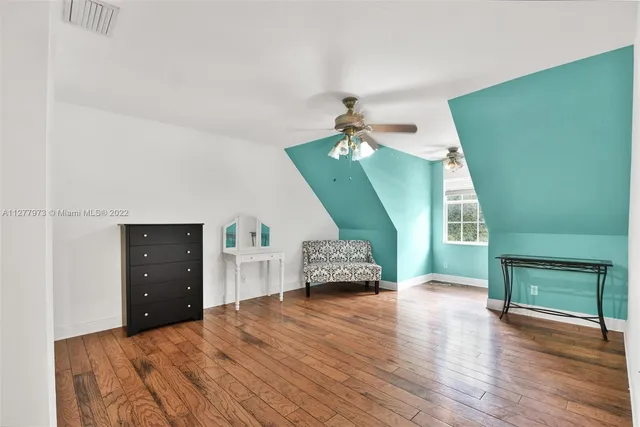 a bedroom with a bed and a mirror