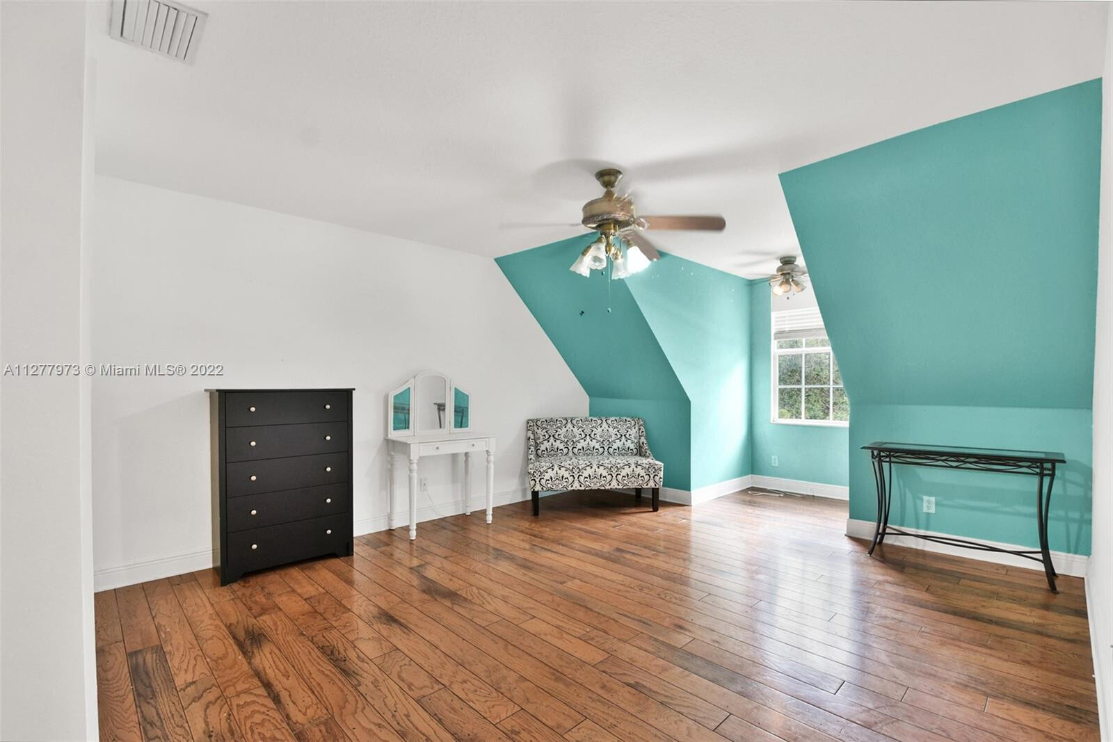 14425 North 64th Court North Loxahatchee, FL 33470 - Photo 27 of 36 a bedroom with a bed and a mirror