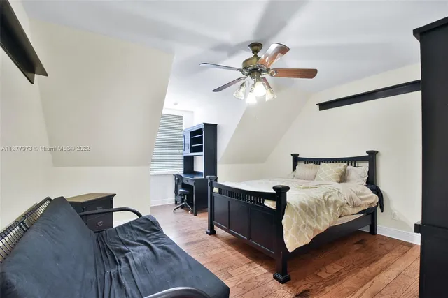 a living room with furniture and a ceiling fan