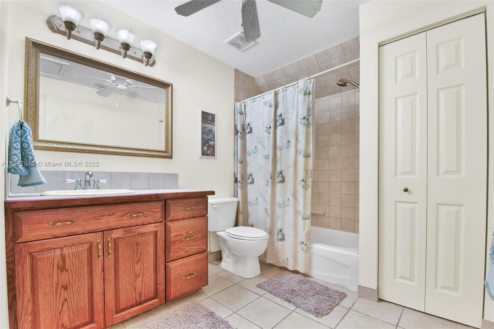 14425 North 64th Court North Loxahatchee, FL 33470 - Photo 29 of 36 a bathroom with a sink a toilet and shower