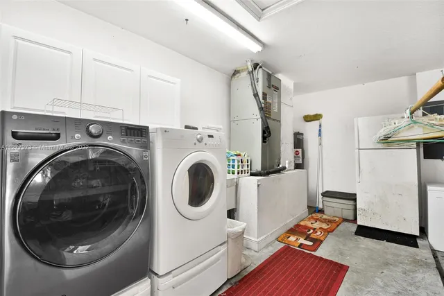 a utility room with sink dryer and washer